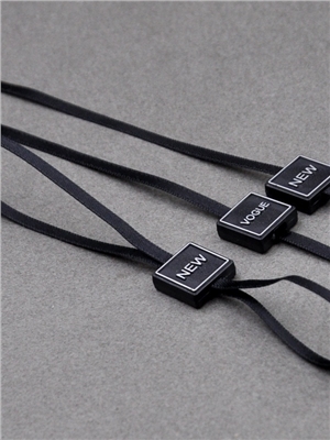 Black ribbon hanging particles